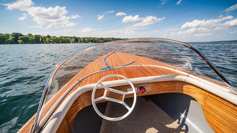 a boat floating on a lake, Choosing a Tender For Your Yacht | YATCO MLS - Yachts for Sale
