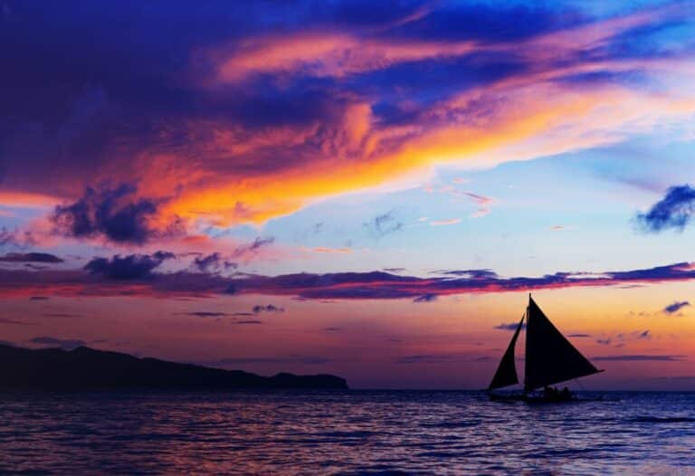 Sailboat sailing into the sunset. Find here the top six expensive sailboats, the highest-priced brand, how much a luxury sailboat costs, and who owns the largest sailboat.