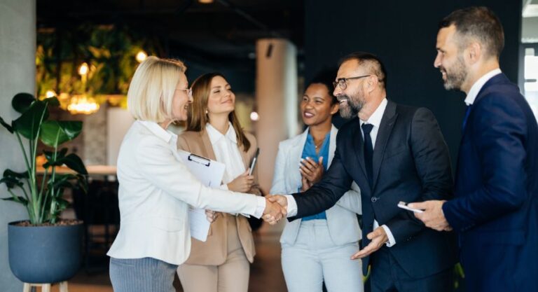 Group of professionals exchanging greetings.