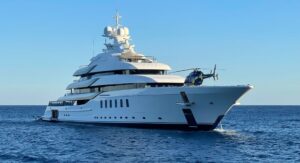 A luxury yacht with helipad sailing in the ocean.