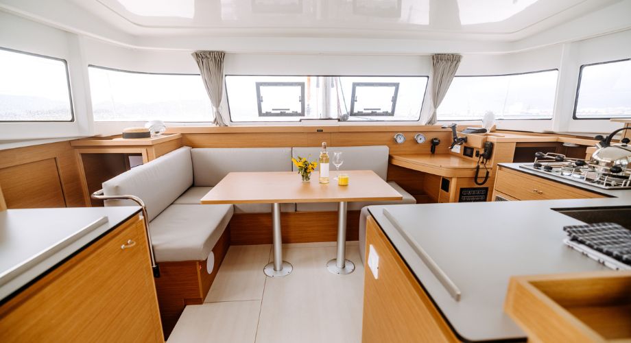 Inside salon of a catamaran. Compare catamarans vs monohulls to find the best fit for your sailing style. Learn about cost, speed, stability, and more.