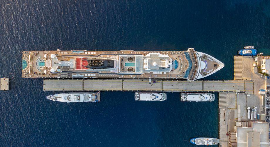 A cruise ship or a yacht sailing in the ocean. Explore pros & cons of a cruise ship vs. yacht. Compare charter cruise options, exclusive amenities, & costs for ultimate luxury sea escape.