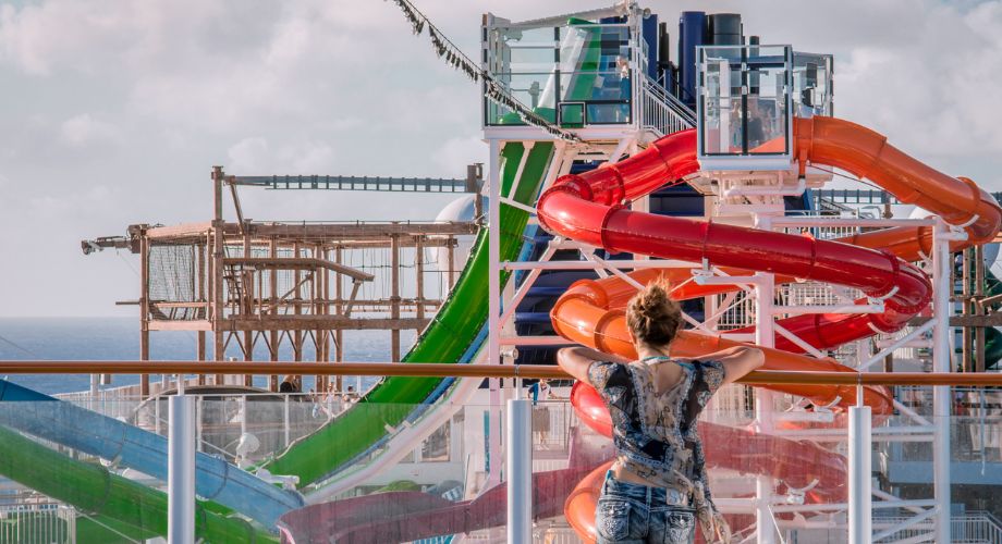 A woman looking at the water slides on a vessel.