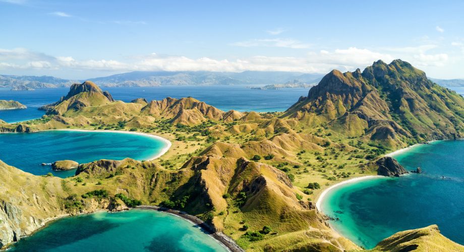 An island with lots of green hill mountains.