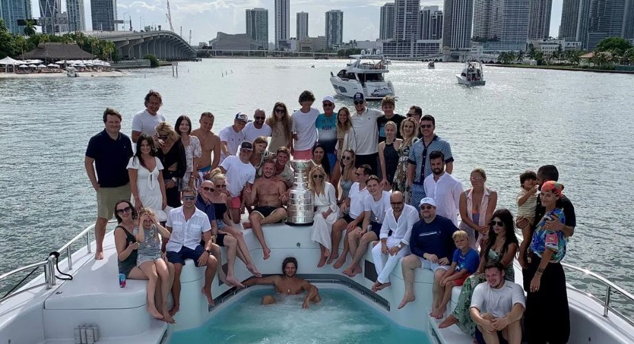 A group of people on a luxury yacht that's sailing in the ocean. With the Florida Panthers winning back-to-back Stanley Cup titles, YATCO looks back at how the team celebrated 2024 victory on water.