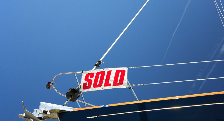 A yacht for sale docked in the ocean. Learn how to sell your yacht without a broker. Discover the best way to sell a used boat online, list your yacht, and avoid common mistakes.