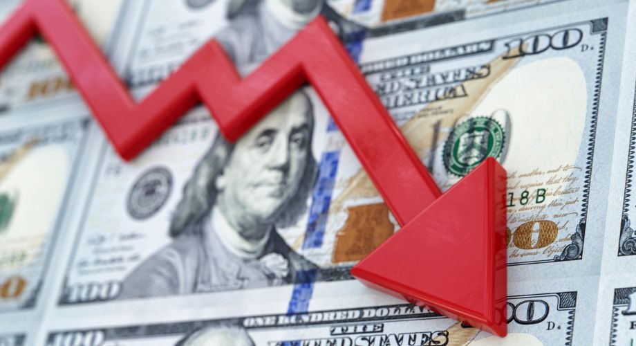 A red downward-pointing zigzag arrow placed over multiple U.S. $100 bills, symbolizing financial decline and yacht depreciation in value.