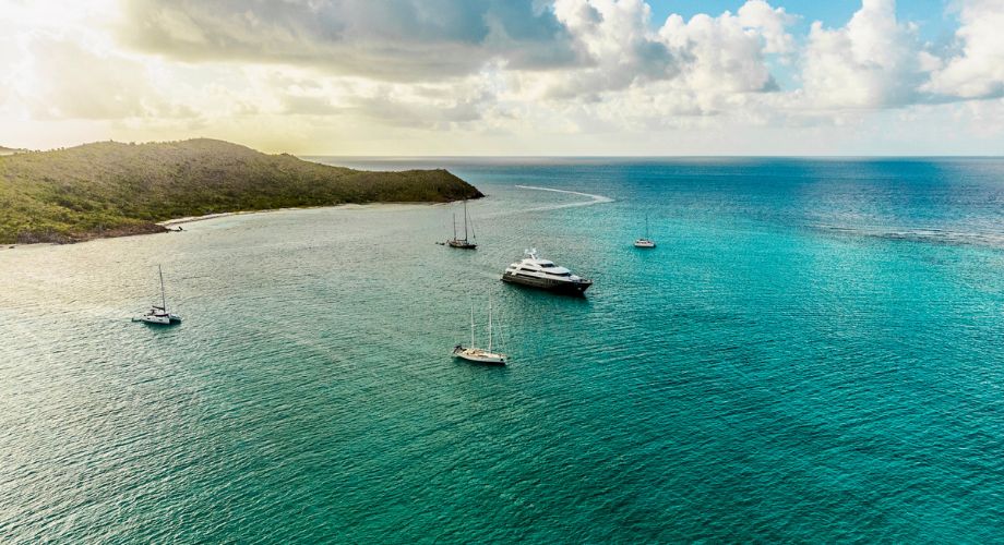 Few luxury vessels sailing in the ocean.
