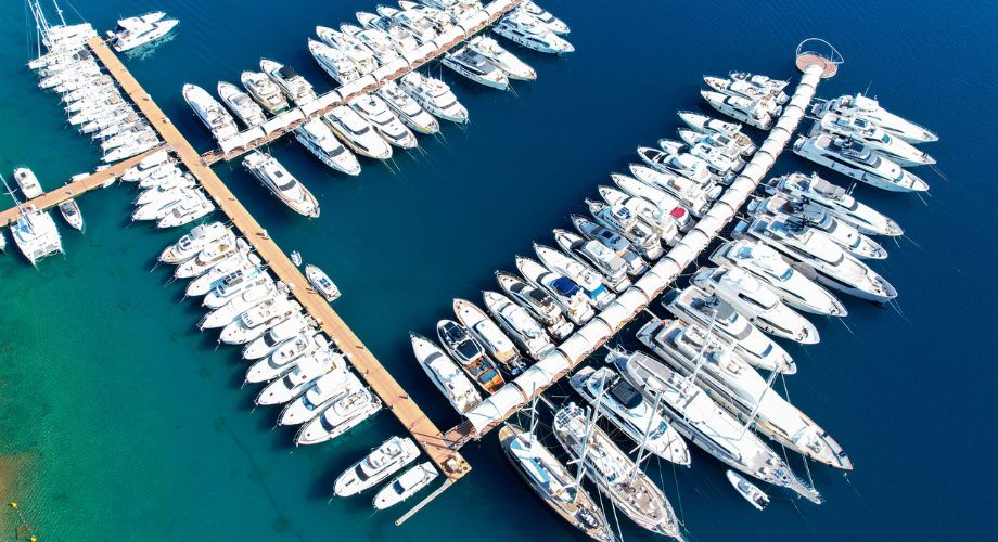 A large number of superyachts docked near the marina. Owning a superyacht is more than the purchase price. Discover hidden costs from maintenance to crew and fuel in this clear cost breakdown.
