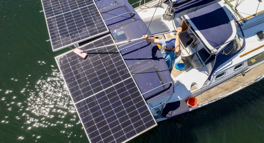 A person sailing on a solar yacht with a solar panel on top of it.