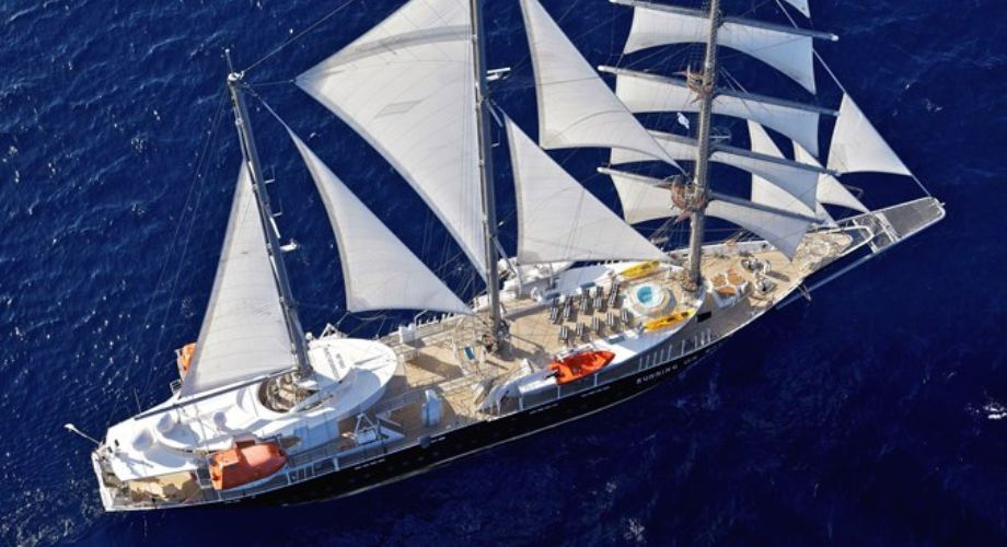 RUNNING ON WAVES sailing yacht that's sailing in the ocean.
