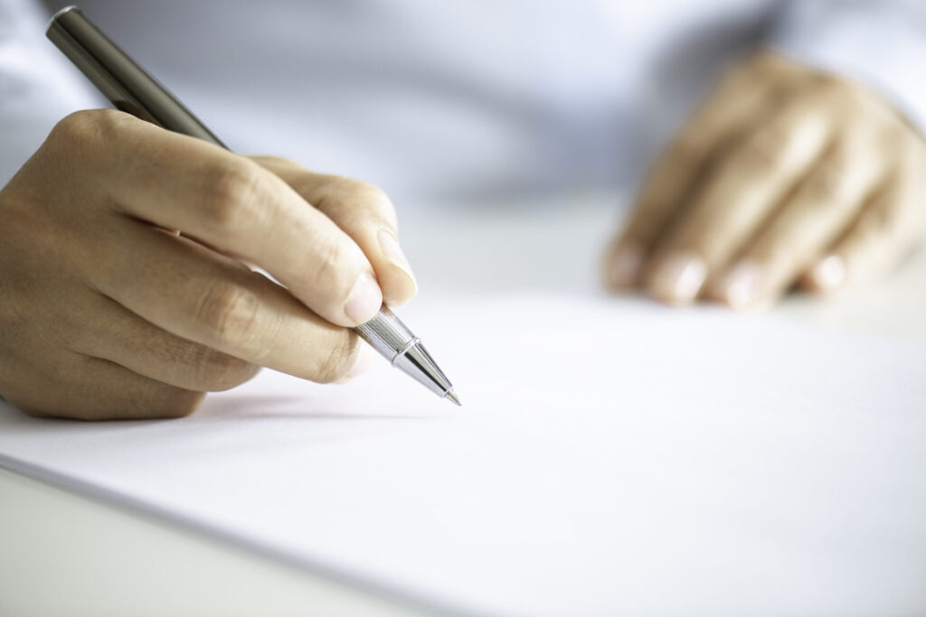 A man signing yacht charter contracts. Understand yacht charter contracts and their types—from bareboat to crewed charters. Learn what to expect before signing the agreement.