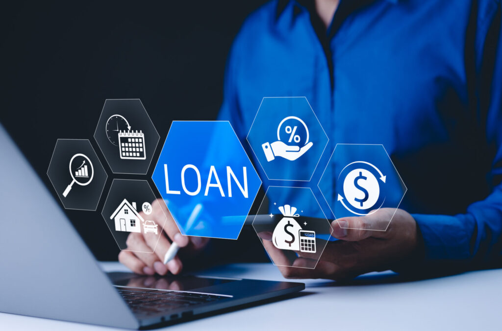 A modern digital loan management, featuring a person using a laptop and smartphone surrounded by floating financial icons related to interest rates, repayment, home and auto loans—highlighting the convenience and complexity of securing financing such as yacht lending in today’s digital age.