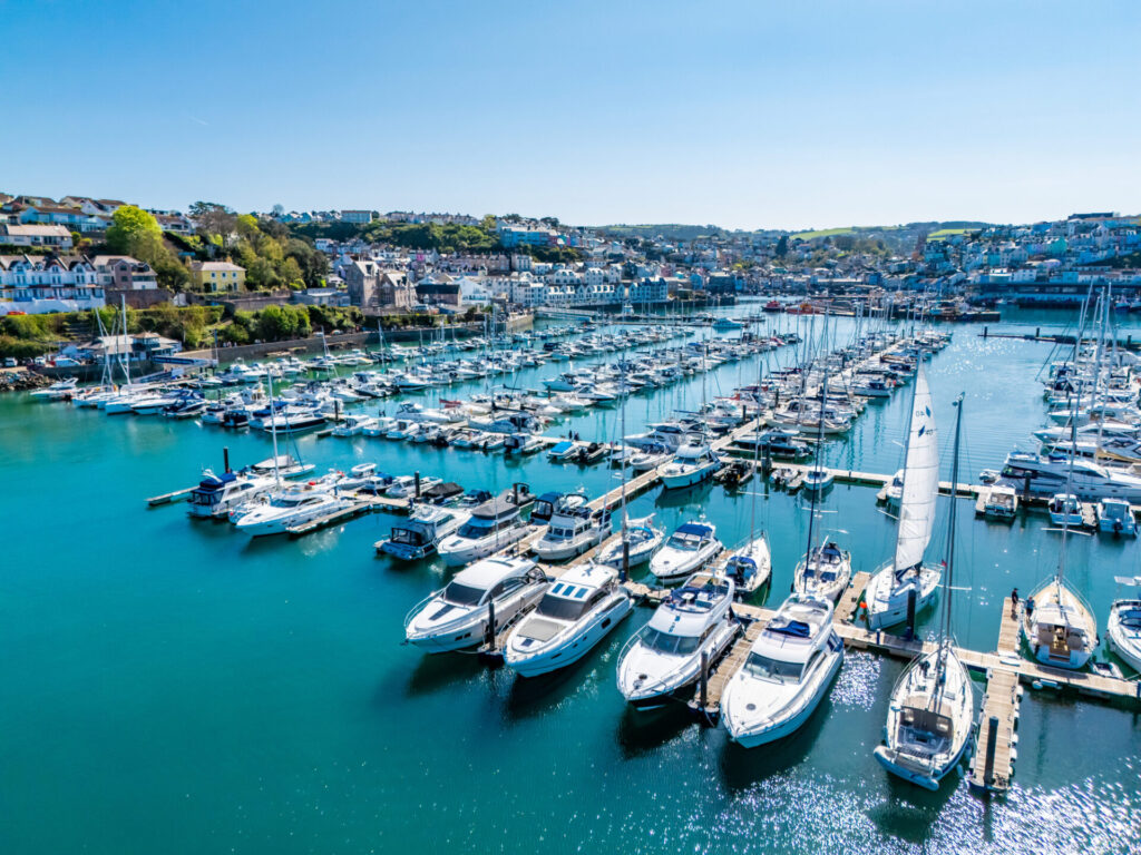 Luxury yachts docked on the ocean. Explore how bank interest rates affect yacht lending. Compare loan options, use calculators, and learn how to finance a yacht purchase.