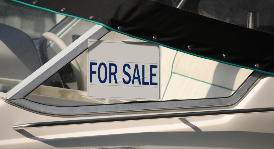 A boat with a for sale sign. Understand what a boat warranty covers, how to make a claim, and compare options from used boat coverage to extended yacht warranties.