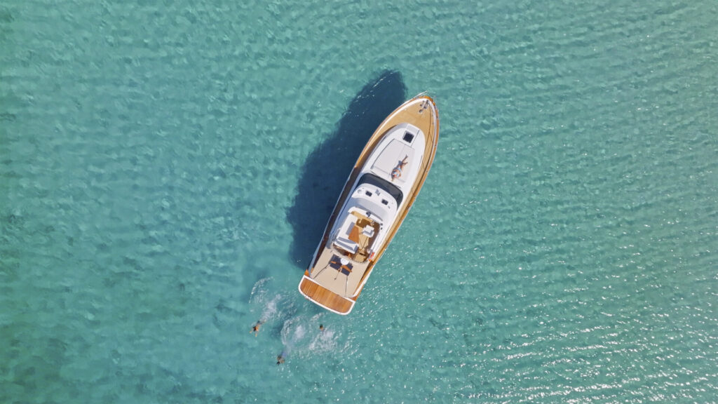 Drones on Deck | Capturing the Yachting Experience | YATCO Aerial view of family swimming and sunbathing in Adriatic Sea during vacation.