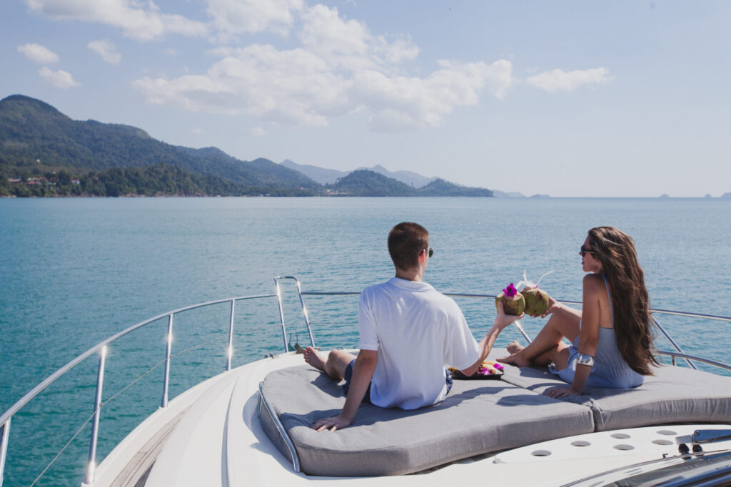 Last Minute Yacht Charter | Where to Find Deals | YATCO A couple enjoying honeymoon onboard of luxury boat.