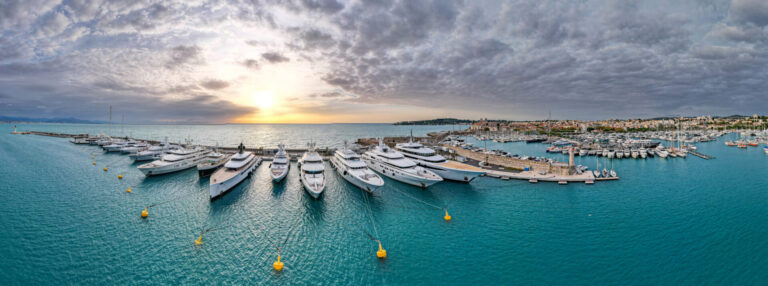 Aerial flyover above the largest super mega yachts in Europe in the French Riviera in the Mediterranean Sea.
