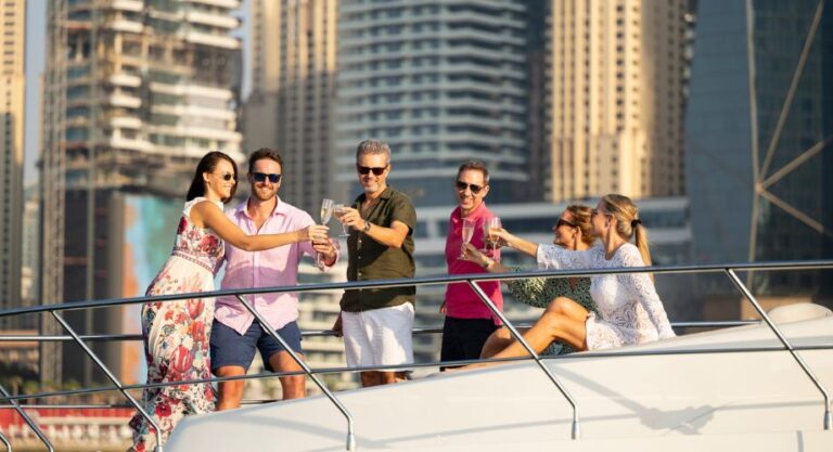 Group of six expatriates having a yacht party and celebrating success and new life with wine on private yacht in the Unites Arab Emirates.