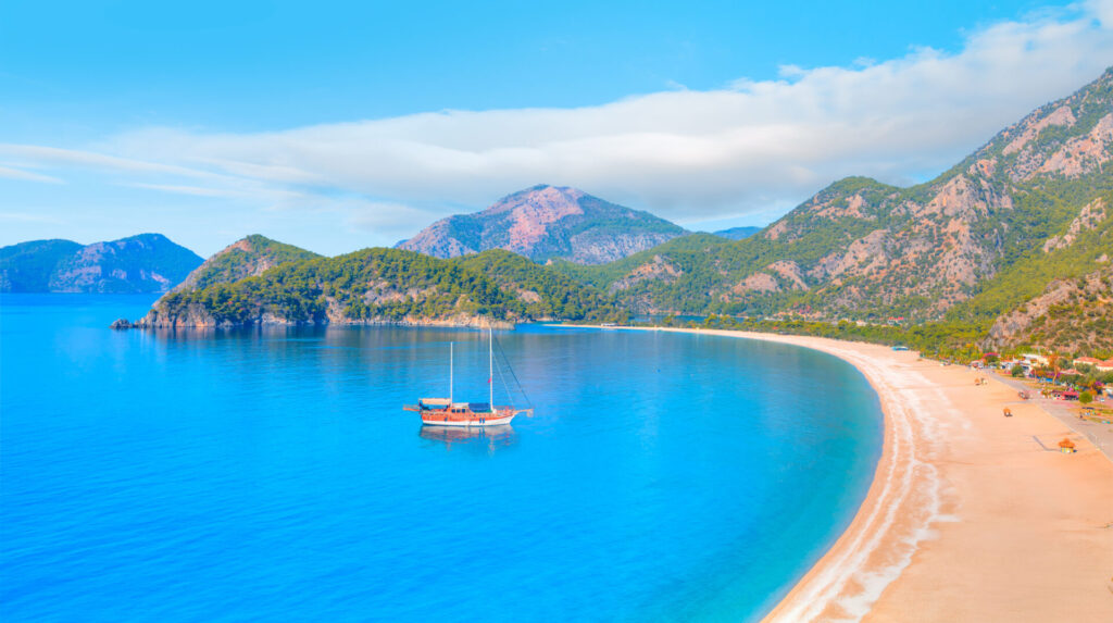 Honeymoon Yacht Charter | Romantic Routes | YATCO Panoramic view of Oludeniz Beach And Blue Lagoon, Oludeniz beach. Plan the ultimate honeymoon yacht charter. Romantic routes in the Mediterranean, Caribbean, Florida, Greece, Italy, and beyond.