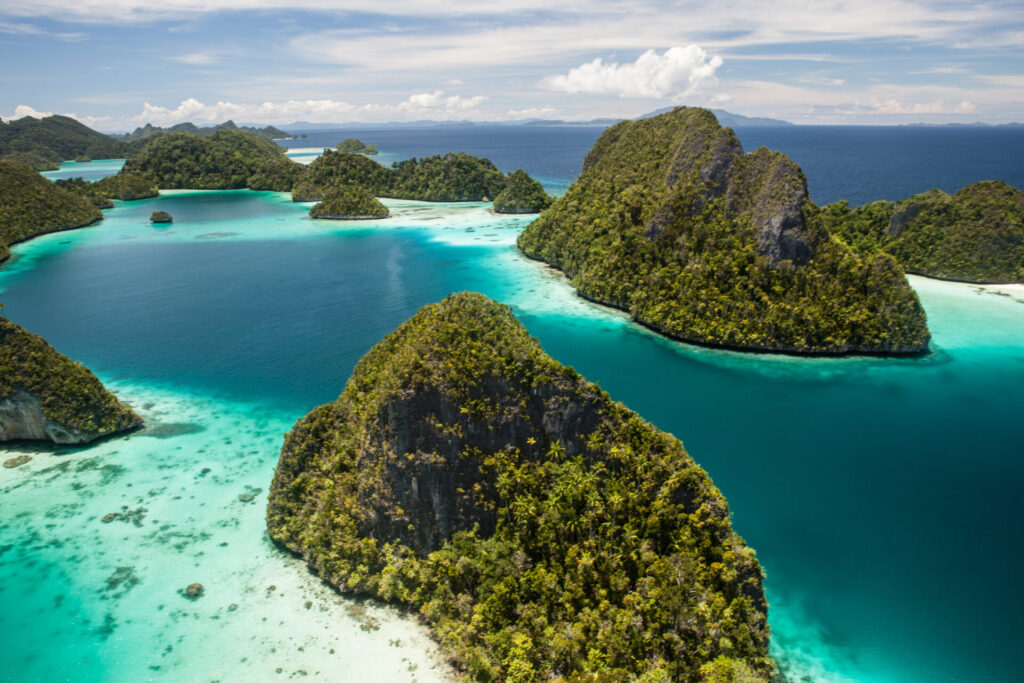 Honeymoon Yacht Charter | Romantic Routes | YATCO Limestone islands surround a remote, tropical lagoon in Wayag, Raja Ampat, Indonesia. Plan the ultimate honeymoon yacht charter. Romantic routes in the Mediterranean, Caribbean, Florida, Greece, Italy, and beyond.