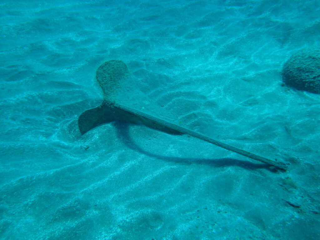 Abandoned yacht anchor on the bottom of the sea.