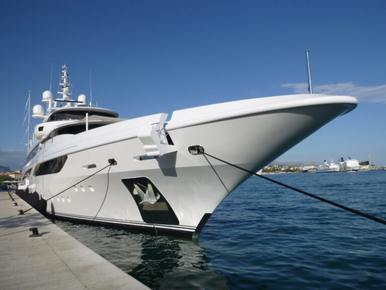 A luxurious yacht docked on a pier in Split, Croatia under a clear blue sky background with yacht provisioning. Learn all about yacht provisioning, from essentials and storage tips to top global suppliers and charter services.