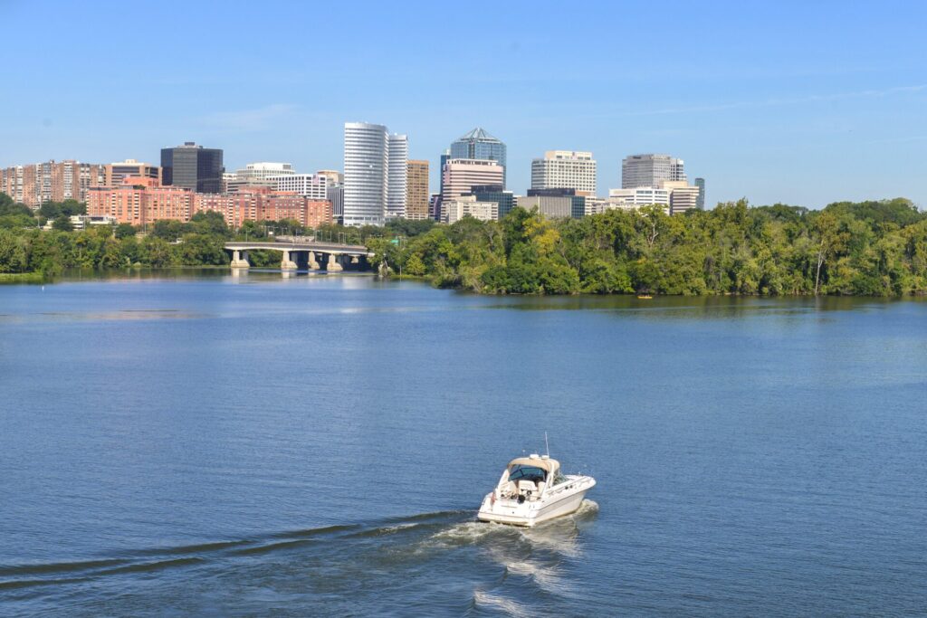 Yachts and Boats in Washington DC | Verified Listings | YATCO A boat sails toward Rosslyn in Potomac River - Washington DC United States of America.