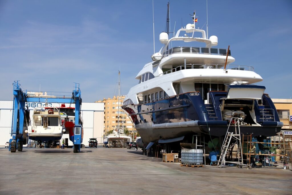Luxury Yacht Market | Maintenance | Insurance | YATCO A luxury yacht is docked for maintenance.