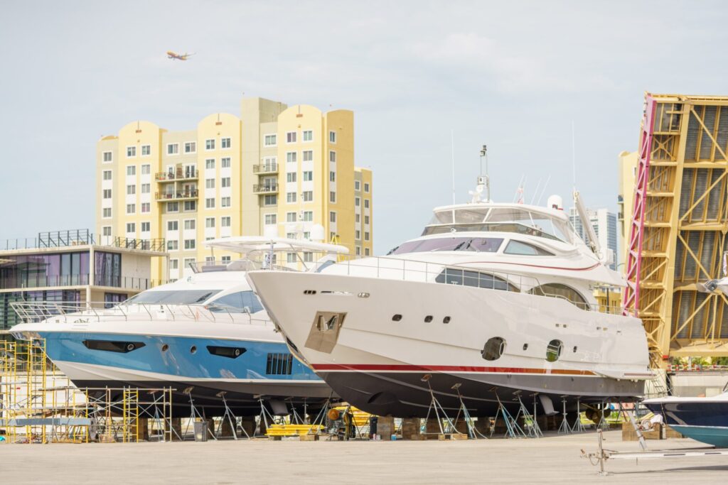 Luxury Yacht Market | Maintenance | Insurance | YATCO Luxury yachts are docked on the ocean.