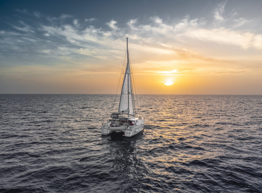 Best Yachts for Global Yacht Circumnavigation | YATCO A sailing catamaran in the Caribbean during a yacht circumnavigation.