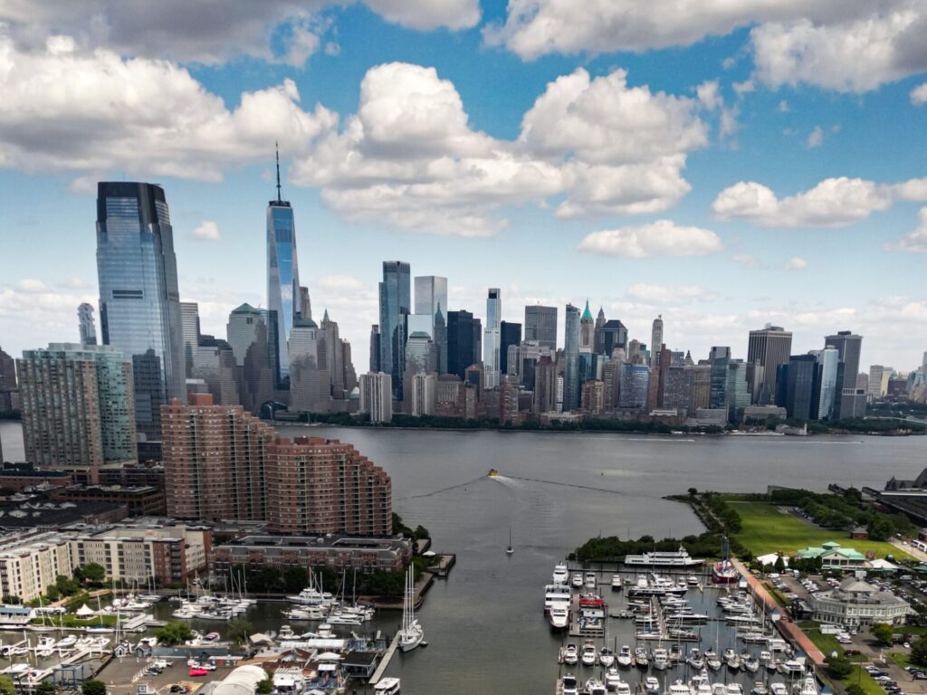 Yachts in New York | Verified Listings | Expert Tips | YATCO A stunning view of Lower Manhattan’s skyline across the Hudson River, with marinas and yachts in the foreground under a partly cloudy sky. Explore verified yachts in New York. Check detailed specs, current prices, and expert buying tips. Find your ideal yacht through YATCO.