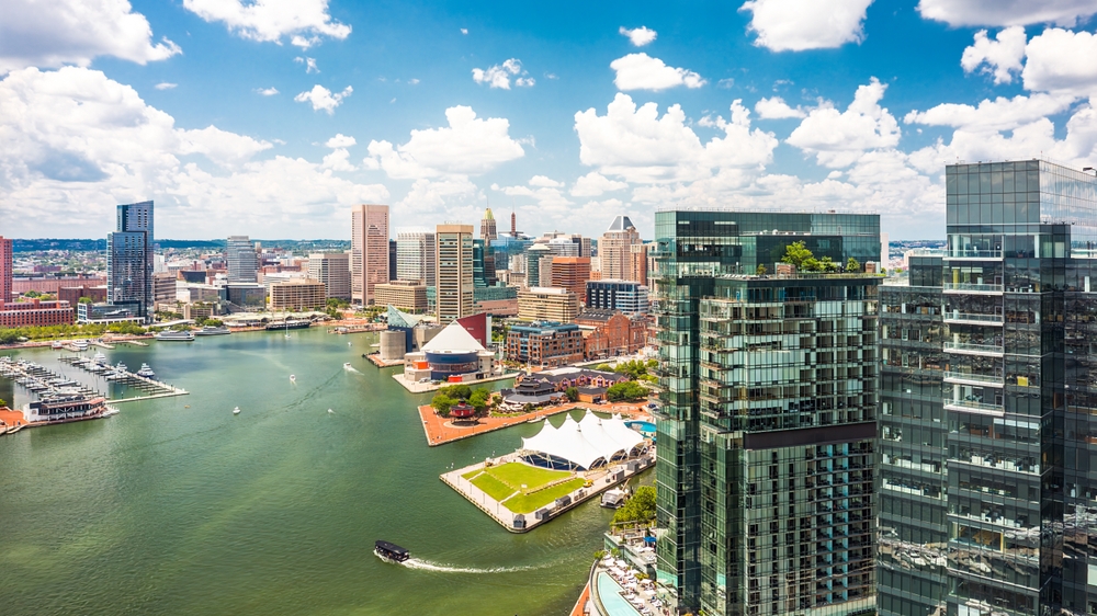 Yachts in Maryland | Listings, Expert Tips & Deals | YATCO Luxury yachts and boats are docked in Maryland, near the skyscrapers.