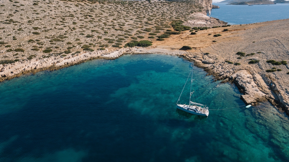 A small luxury yacht sailing on the ocean.