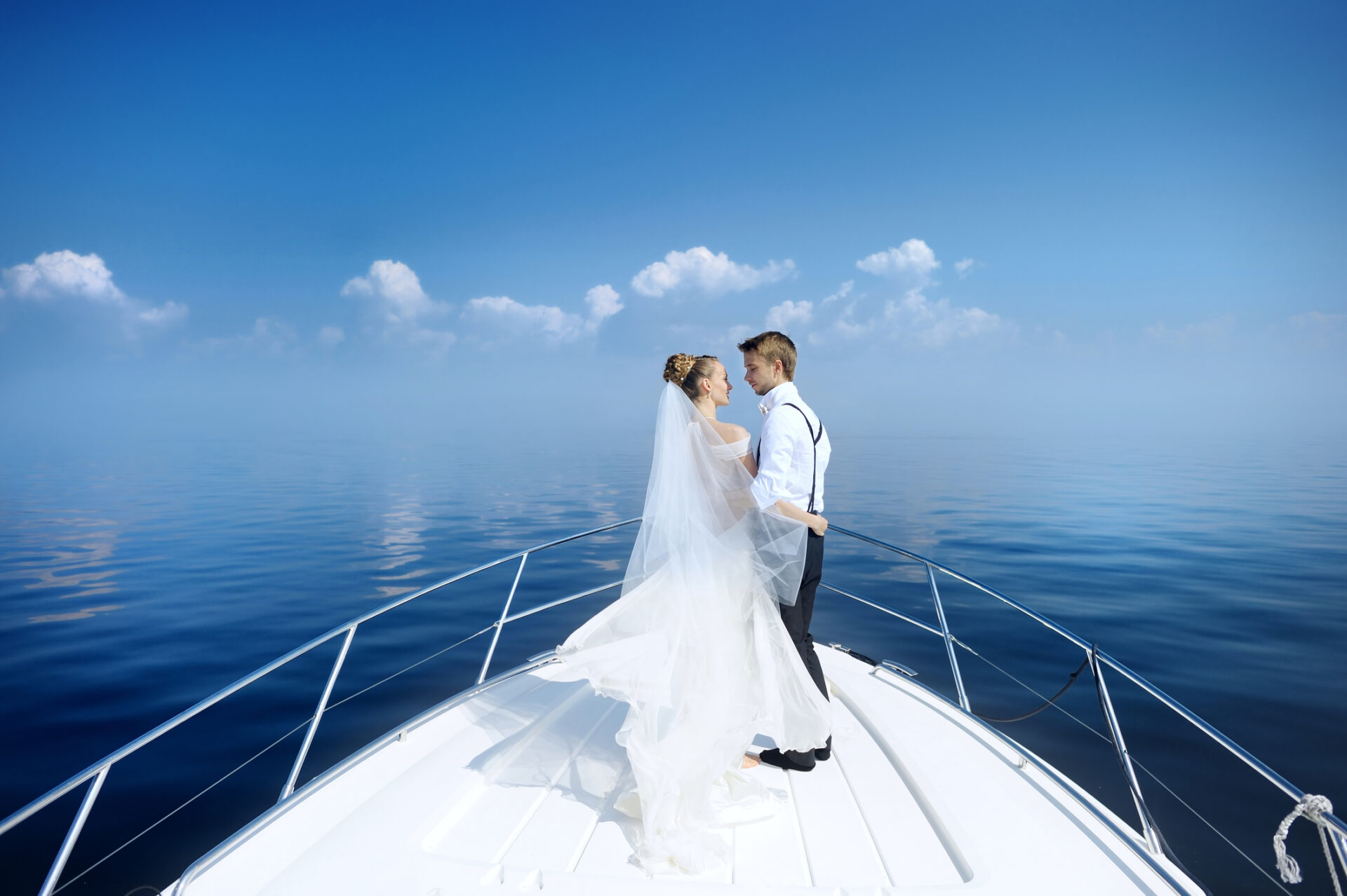 Small Yacht Trends 2026 | Owner-Operator Options | YATCO bride and groom hugging on a yacht