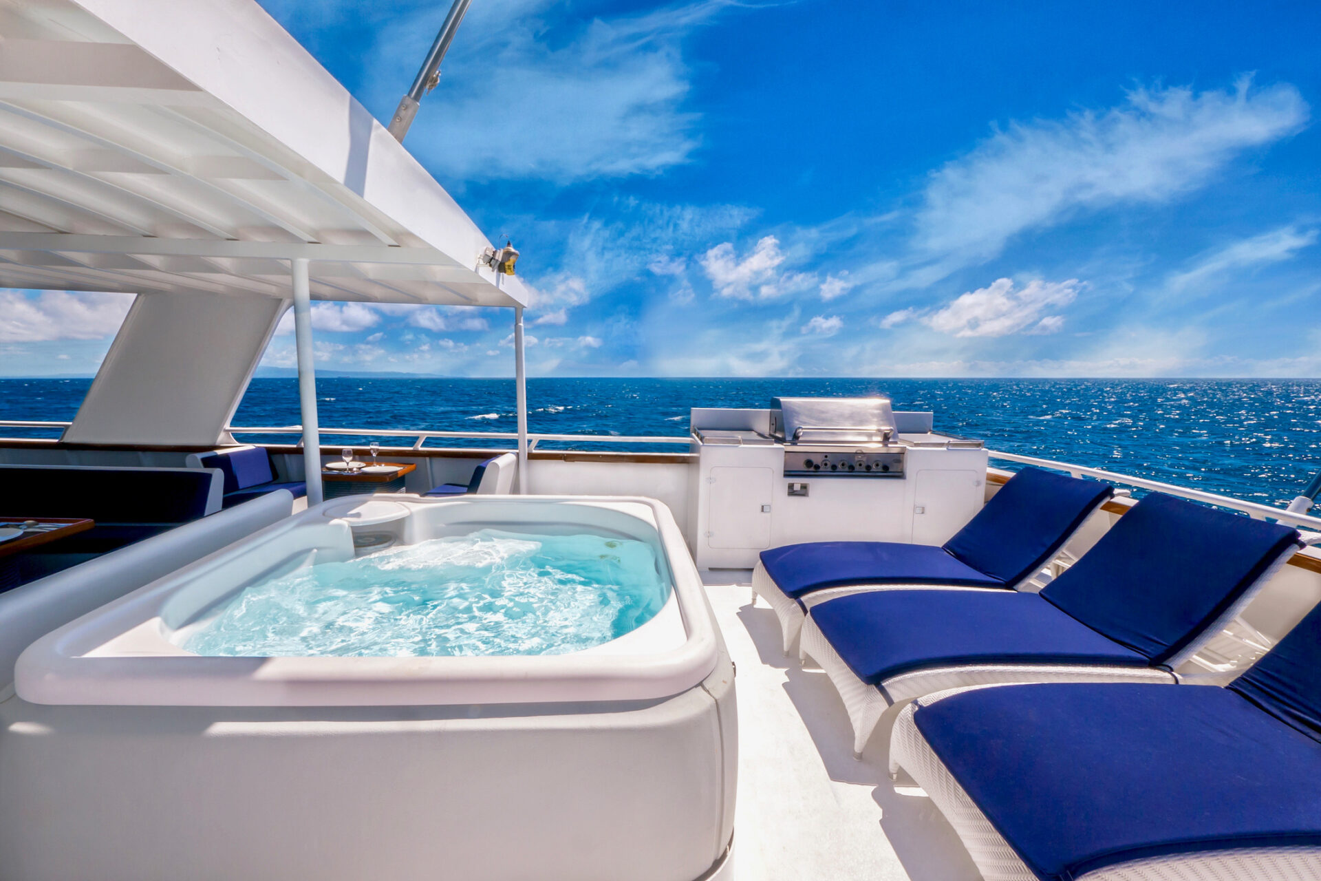 Small Yacht Trends 2026 | Owner-Operator Options | YATCO yacht with white deck, blue chairs, and a jacuzzi