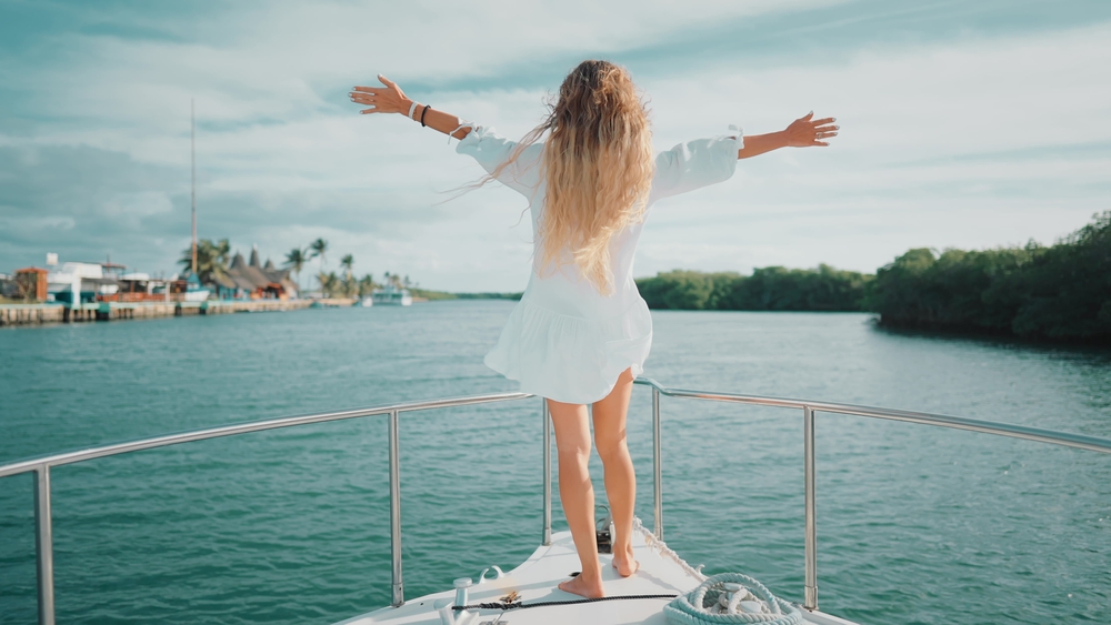 Small Yacht Trends 2026 | Owner-Operator Options | YATCO woman with open arms on yacht deck